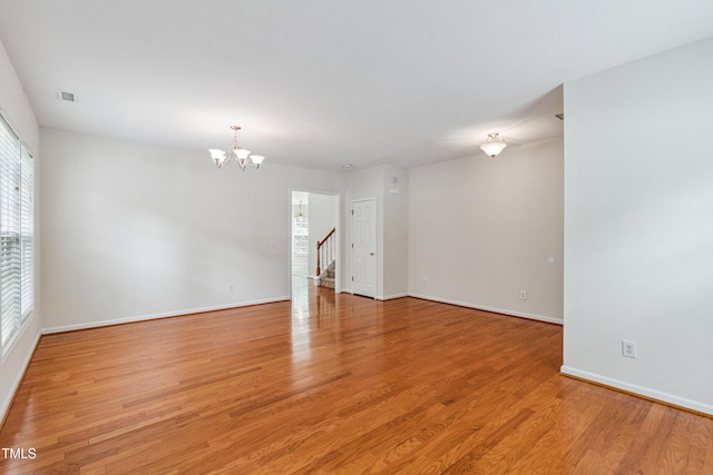 2228 Cedar Grove Dr, Durham, NC 27703 - spare room with a chandelier, light wood finished floors, and stairway
