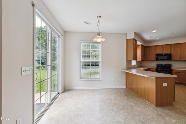 2228 Cedar Grove Dr, Durham, NC 27703 - kitchen with black appliances, light countertops, brown cabinets, a peninsula, and pendant lighting