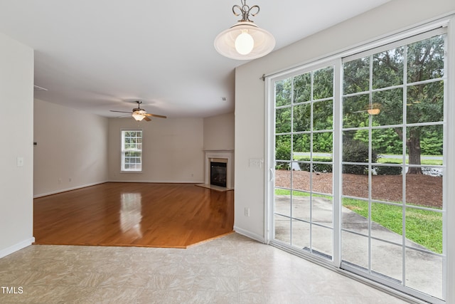 2228 Cedar Grove Dr, Durham, NC 27703 - unfurnished living room with ceiling fan, a fireplace with flush hearth, and tile patterned floors
