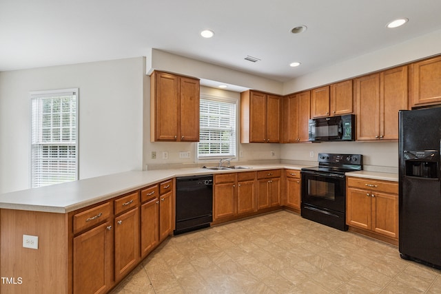 2228 Cedar Grove Dr, Durham, NC 27703 - kitchen featuring black appliances, healthy amount of natural light, brown cabinets, and recessed lighting