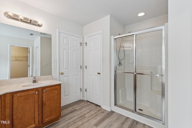 2228 Cedar Grove Dr, Durham, NC 27703 - bathroom featuring a shower stall, vanity, and wood finished floors