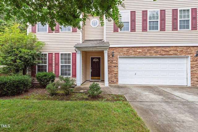 2228 Cedar Grove Dr, Durham, NC 27703 - traditional home with driveway, a garage, a front lawn, and stone siding