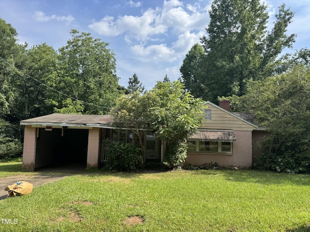 2701 Garfield St, Raleigh, NC 27603 - view of front facade featuring concrete block siding, driveway, a front yard, a chimney, and an attached garage