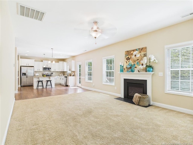 448 Pittfield Run, Cameron, NC 28326 - living area featuring light carpet, plenty of natural light, ceiling fan, a fireplace with flush hearth, and recessed lighting