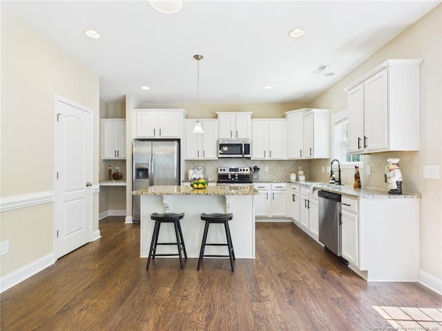 448 Pittfield Run, Cameron, NC 28326 - kitchen featuring stainless steel appliances, dark wood-type flooring, a breakfast bar area, white cabinets, and recessed lighting