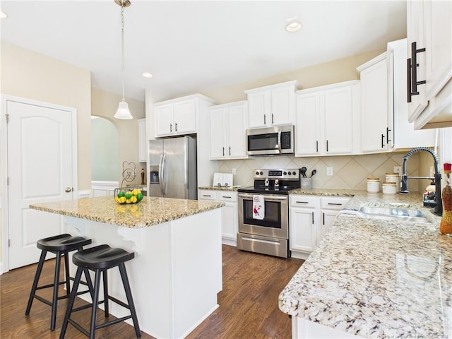 448 Pittfield Run, Cameron, NC 28326 - kitchen with stainless steel appliances, a center island, dark wood-style flooring, white cabinets, and recessed lighting