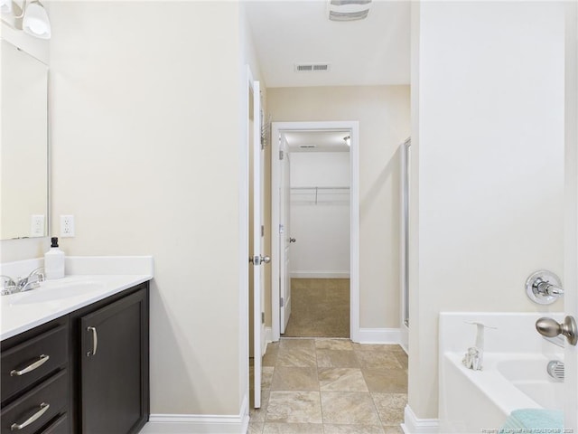 448 Pittfield Run, Cameron, NC 28326 - bathroom with vanity, a spacious closet, a stall shower, and a garden tub