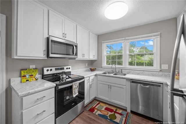 615 Wallingford Ct, Fayetteville, NC 28314 - kitchen featuring stainless steel appliances, a textured ceiling, light countertops, and white cabinets