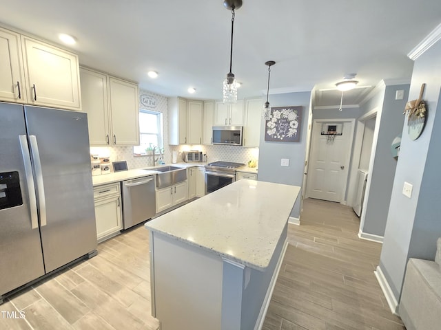 4411 Fairland Ct, Burlington, NC 27215 - kitchen with stainless steel appliances, light wood-type flooring, tasteful backsplash, ornamental molding, and a center island