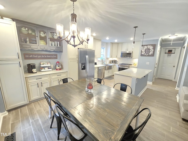 4411 Fairland Ct, Burlington, NC 27215 - dining area featuring light wood-type flooring, recessed lighting, a chandelier, ornamental molding, and attic access