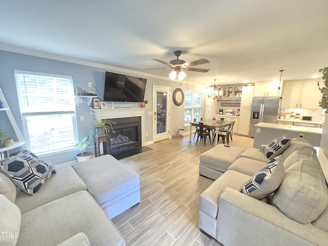 4411 Fairland Ct, Burlington, NC 27215 - living area featuring ceiling fan, a fireplace with flush hearth, light wood-type flooring, and ornamental molding