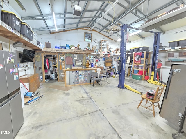4411 Fairland Ct, Burlington, NC 27215 - garage featuring freestanding refrigerator, a workshop area, and a garage door opener