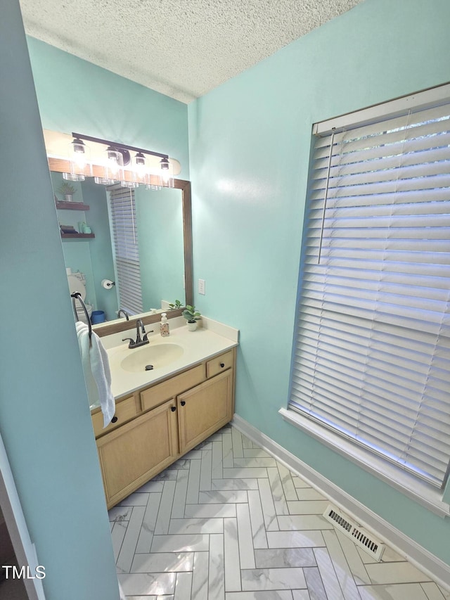 4411 Fairland Ct, Burlington, NC 27215 - bathroom with a textured ceiling and vanity