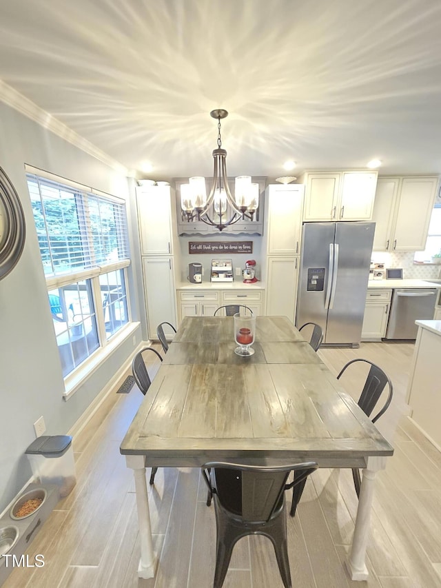 4411 Fairland Ct, Burlington, NC 27215 - dining area featuring a chandelier, crown molding, and light wood-type flooring