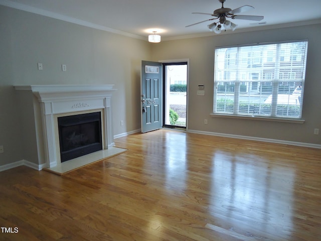 8315 City Loft Ct, Raleigh, NC 27613 - unfurnished living room with a ceiling fan, crown molding, wood finished floors, and a fireplace
