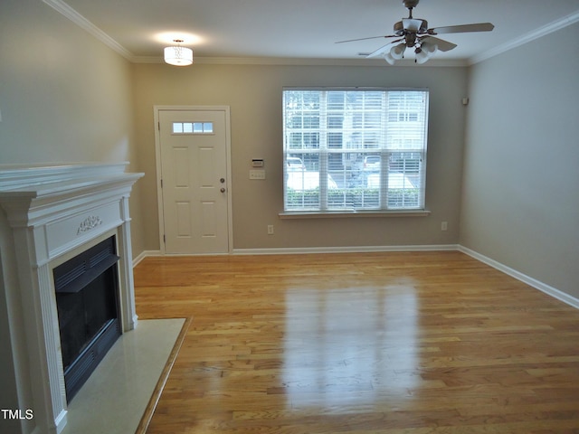 8315 City Loft Ct, Raleigh, NC 27613 - entryway featuring a fireplace with flush hearth, ceiling fan, ornamental molding, and light wood finished floors