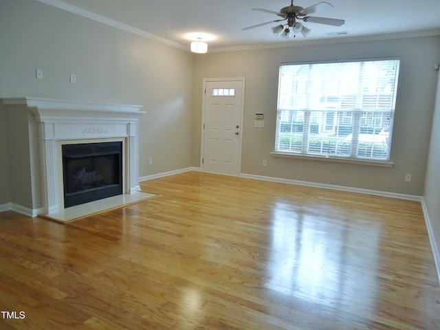 8315 City Loft Ct, Raleigh, NC 27613 - unfurnished living room with a ceiling fan, light wood-style flooring, ornamental molding, and a fireplace with flush hearth