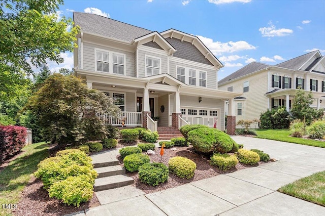 2800 Royal Forrest Dr, Raleigh, NC 27614 - craftsman-style house featuring covered porch, an attached garage, driveway, and brick siding