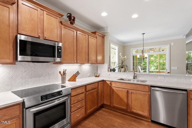 2800 Royal Forrest Dr, Raleigh, NC 27614 - kitchen with appliances with stainless steel finishes, ornamental molding, wood finished floors, light countertops, and plenty of natural light