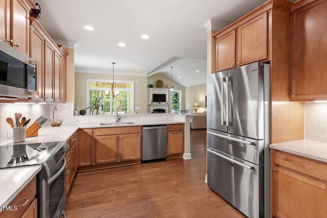 2800 Royal Forrest Dr, Raleigh, NC 27614 - kitchen with appliances with stainless steel finishes, crown molding, wood finished floors, decorative backsplash, and open floor plan