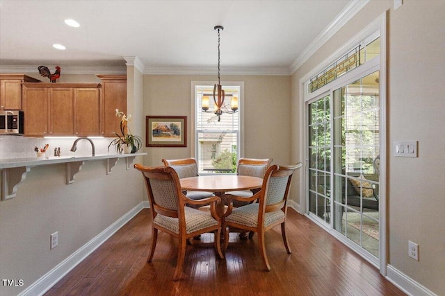 2800 Royal Forrest Dr, Raleigh, NC 27614 - dining room with dark wood-type flooring, ornamental molding, a chandelier, and recessed lighting