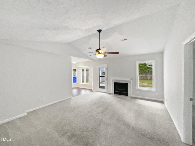 1628 Winnabow Dr, Fayetteville, NC 28304 - unfurnished living room featuring lofted ceiling, carpet, a premium fireplace, a ceiling fan, and a textured ceiling