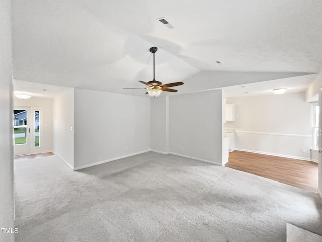 1628 Winnabow Dr, Fayetteville, NC 28304 - unfurnished living room with carpet floors, vaulted ceiling, and a ceiling fan