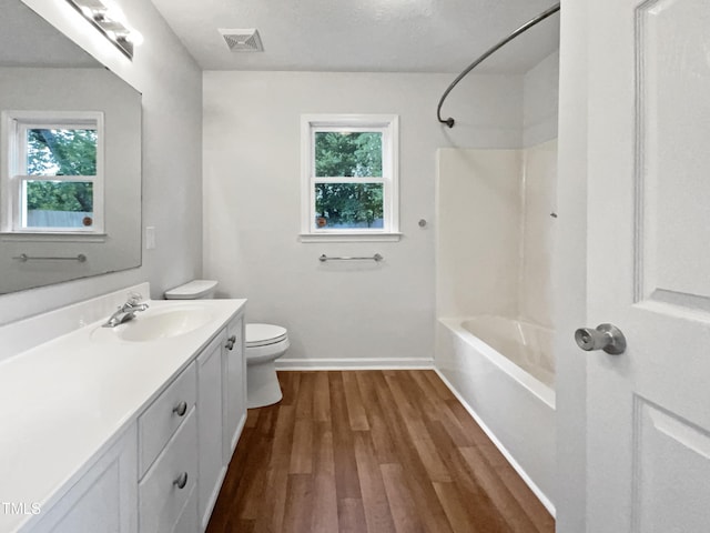 1628 Winnabow Dr, Fayetteville, NC 28304 - full bath with plenty of natural light, vanity, wood finished floors, and washtub / shower combination