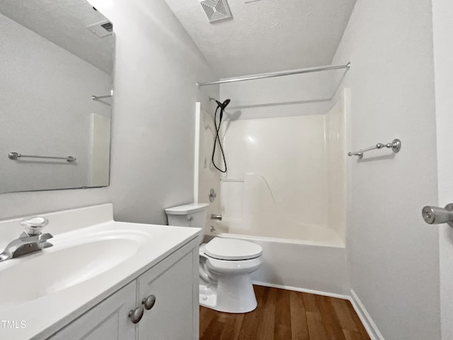 1628 Winnabow Dr, Fayetteville, NC 28304 - full bathroom featuring vanity, wood finished floors,  shower combination, and a textured ceiling