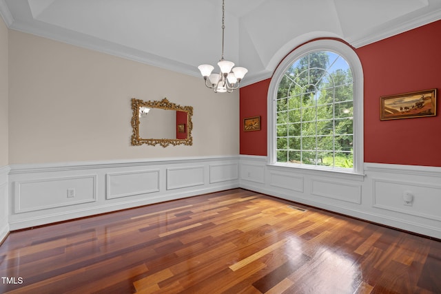 430 Beechwood Trl, Henderson, NC 27536 - empty room featuring plenty of natural light, a chandelier, a wainscoted wall, wood finished floors, and vaulted ceiling