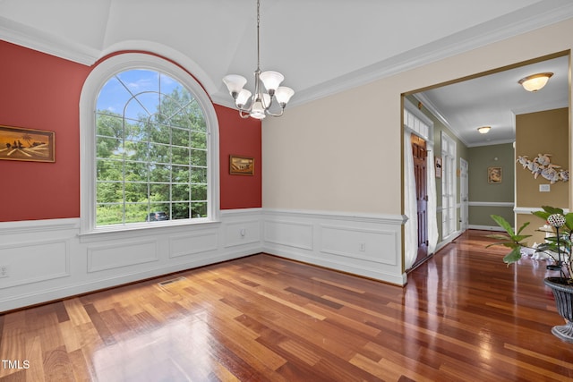 430 Beechwood Trl, Henderson, NC 27536 - unfurnished room with a wainscoted wall, crown molding, wood finished floors, and a chandelier