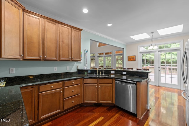 430 Beechwood Trl, Henderson, NC 27536 - kitchen featuring dishwasher, a skylight, dark wood-style floors, crown molding, and brown cabinetry