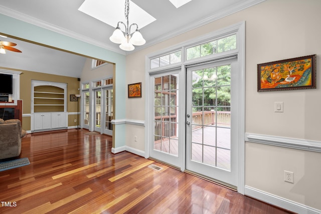 430 Beechwood Trl, Henderson, NC 27536 - entryway with a chandelier, a skylight, wood finished floors, crown molding, and french doors
