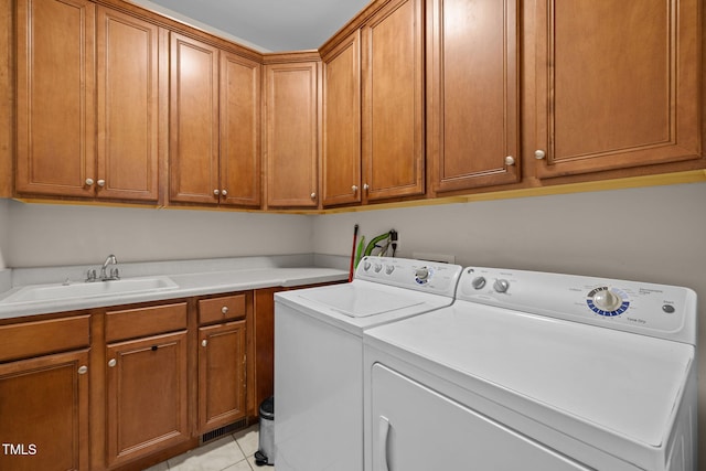 430 Beechwood Trl, Henderson, NC 27536 - laundry area with cabinet space, washer and clothes dryer, and light tile patterned floors
