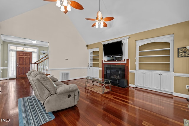 430 Beechwood Trl, Henderson, NC 27536 - living room with built in shelves, high vaulted ceiling, a ceiling fan, a fireplace, and wood finished floors