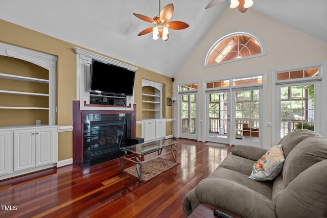 430 Beechwood Trl, Henderson, NC 27536 - living area with a ceiling fan, built in shelves, plenty of natural light, dark wood-style floors, and high vaulted ceiling
