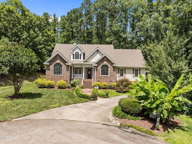 430 Beechwood Trl, Henderson, NC 27536 - view of front of property with brick siding, a front yard, view of scattered trees, and driveway