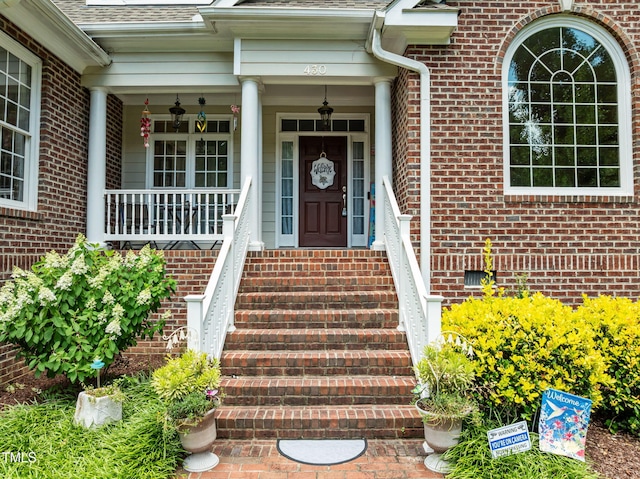 430 Beechwood Trl, Henderson, NC 27536 - entrance to property with roof with shingles, brick siding, and a porch