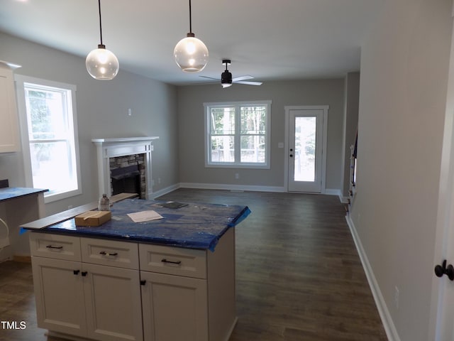 560 S N C 39 Hwy, Louisburg, NC 27549 - kitchen with white cabinetry, open floor plan, a fireplace, a ceiling fan, and dark wood-style floors