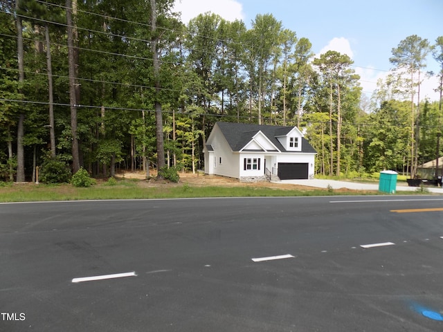 560 S N C 39 Hwy, Louisburg, NC 27549 - modern farmhouse featuring a garage, driveway, and view of wooded area