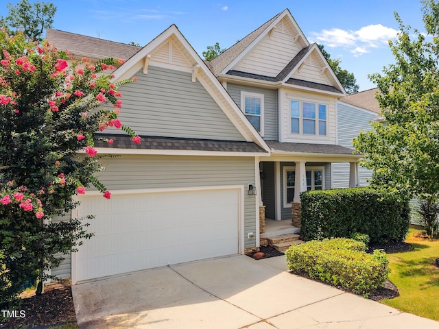 111 Court Jester Way, Morrisville, NC 27560 - view of front of home featuring driveway, covered porch, a garage, and a shingled roof