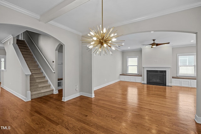 111 Court Jester Way, Morrisville, NC 27560 - unfurnished living room featuring wood finished floors, ceiling fan, arched walkways, a fireplace with flush hearth, and ornamental molding