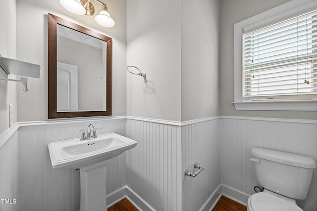 111 Court Jester Way, Morrisville, NC 27560 - half bath featuring a wainscoted wall and wood finished floors