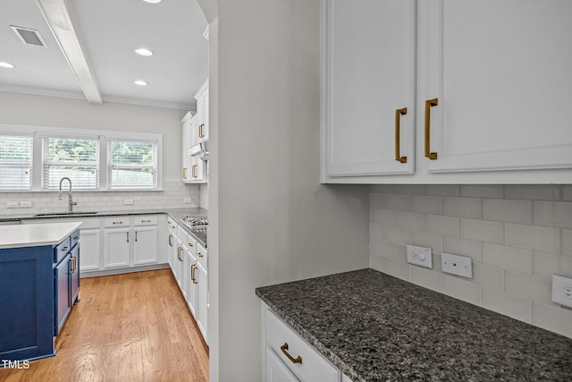 111 Court Jester Way, Morrisville, NC 27560 - kitchen featuring blue cabinetry, decorative backsplash, light wood-type flooring, beamed ceiling, and white cabinets