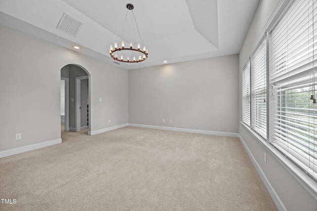 111 Court Jester Way, Morrisville, NC 27560 - unfurnished room with arched walkways, a chandelier, light carpet, a raised ceiling, and recessed lighting