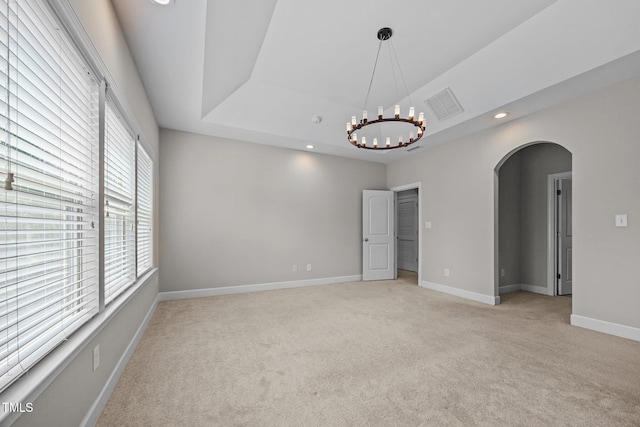 111 Court Jester Way, Morrisville, NC 27560 - unfurnished room featuring arched walkways, a tray ceiling, light carpet, recessed lighting, and a chandelier