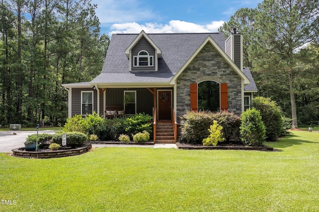 1128 Old Stage Rd S, Erwin, NC 28339 - view of front of house with a porch, a front yard, a chimney, board and batten siding, and roof with shingles