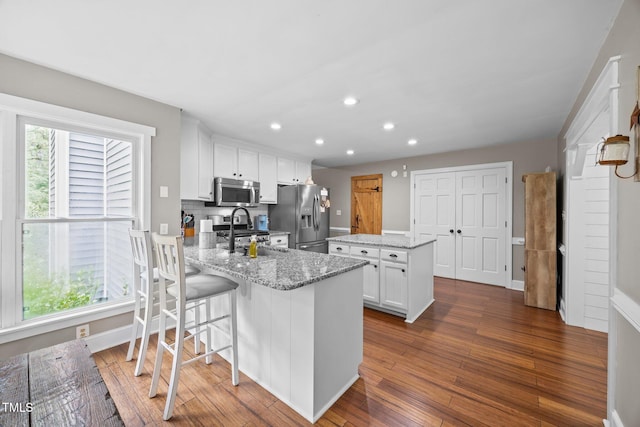 1128 Old Stage Rd S, Erwin, NC 28339 - kitchen featuring stainless steel appliances, recessed lighting, a center island, white cabinets, and dark wood-style flooring