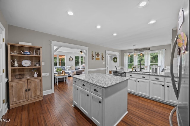 1128 Old Stage Rd S, Erwin, NC 28339 - kitchen featuring a center island, stainless steel appliances, a ceiling fan, recessed lighting, and light stone countertops