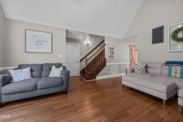 1128 Old Stage Rd S, Erwin, NC 28339 - living area featuring wood finished floors, stairs, and high vaulted ceiling
